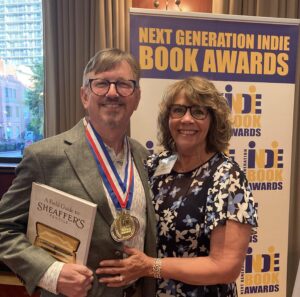 Jonathan Veley wearing his medal for Next Generation Indie Book Award and holding his book "A Field Guide to Sheaffer's Pencils."